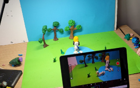 Ipad, clay figures, light, blue and green paper - typical set up for Stop Motion background
