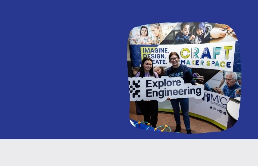 two people holding the foam saying Explore Engineering